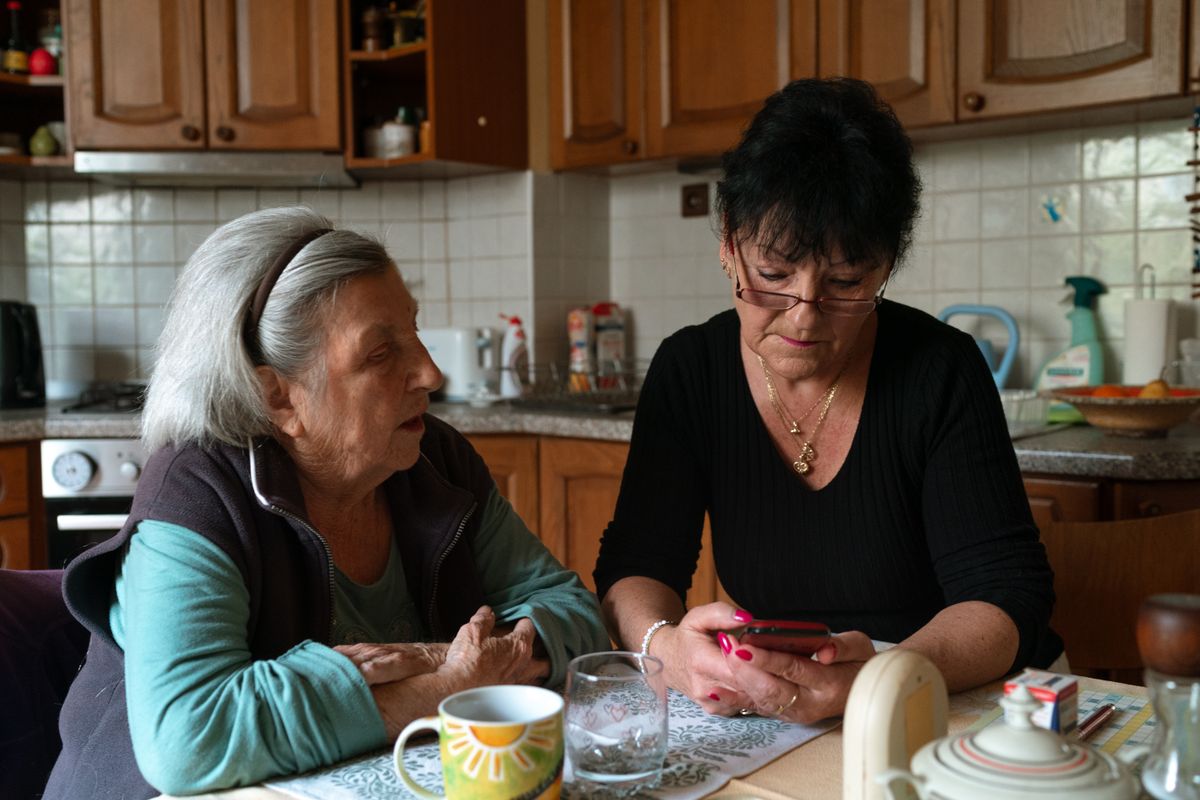 Caregiver spending time with clients over a shared activity