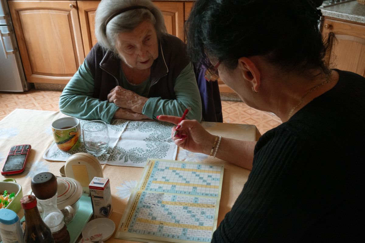Caregiver engaging clients in a cognitive activity