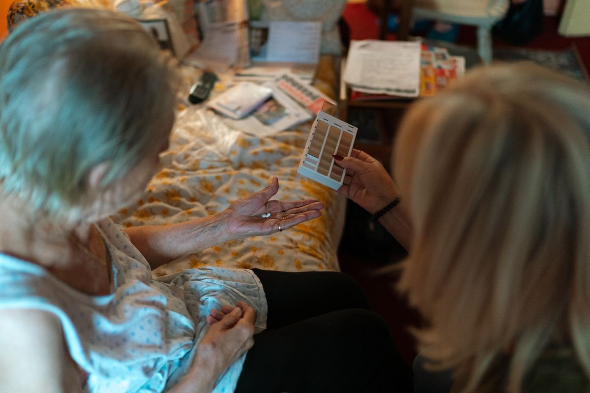 Caregiver reviewing a medication schedule with a client